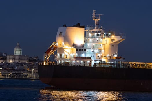 Bright lights on an industrial vessel in the evening. Mid shot