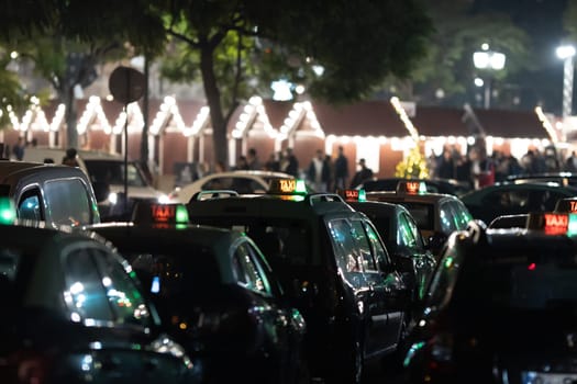 Parked taxi cars in Europe at night. Mid shot
