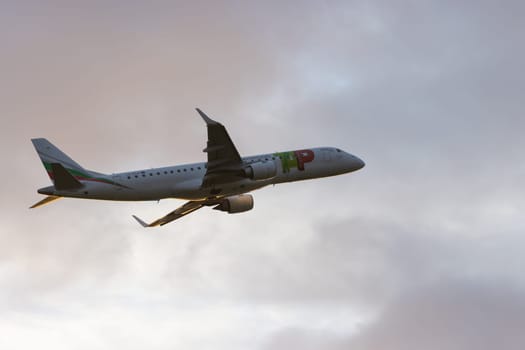 30 November 2022 PORTUGAL, LISBON: an AIRPORTUGAL airplane gains altitude at early sunset. Mid shot