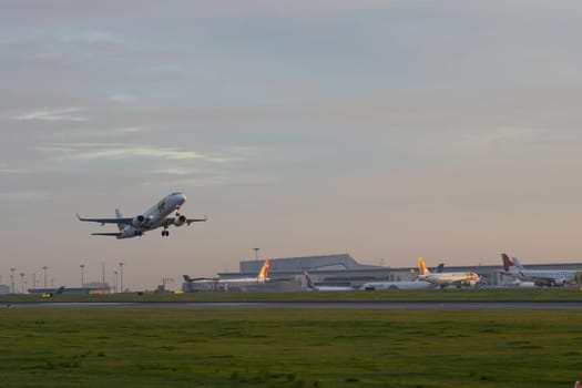 30 November 2022 PORTUGAL, LISBON: an AIRPORTUGAL passenger airplane takes off the runway at early sunset. Mid shot
