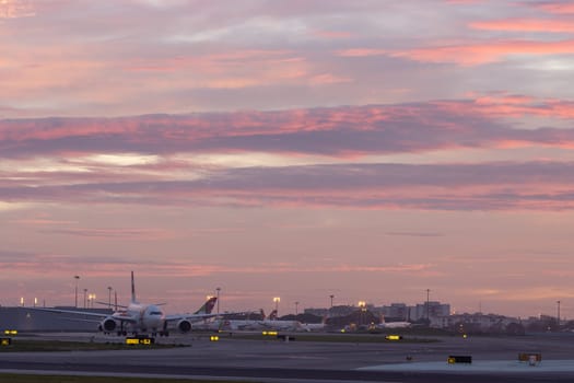 30 November 2022 PORTUGAL, LISBON: airplane field at purple sunset. Mid shot