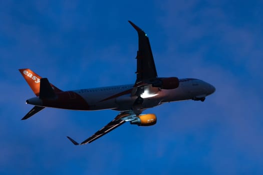30 November 2022 PORTUGAL, LISBON: EASYJET airplane flying in evening sky. Mid shot
