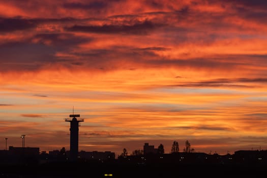30 November 2022 PORTUGAL, LISBON: bright red sunset over the airport. Mid shot