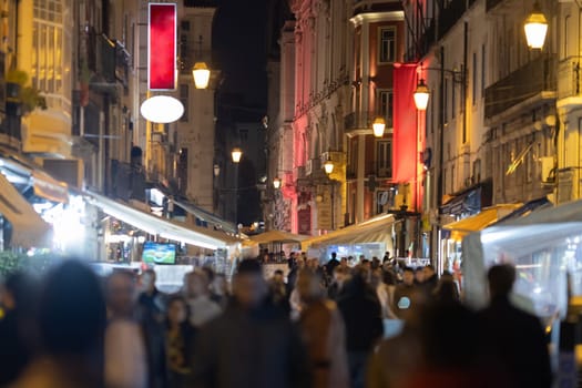 People walking in the narrow street of Lisbon. Mid shot