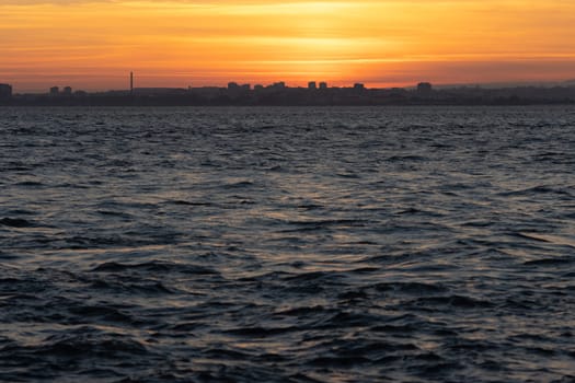 River water surface at an orange sunset. Mid shot