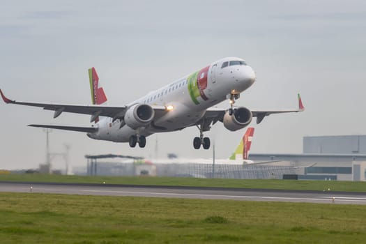 30 November 2022 PORTUGAL, LISBON: an AIRPORTUGAL airplane takes off the runway in grey cloudy weather. Mid shot