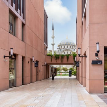 Istanbul, Turkey - May 5, 2023: Internal passage at Galataport mixed use development, with Nusretiye imperial Ottoman Mosque at the far end, located along shore of Bosphorus strait, Karakoy district