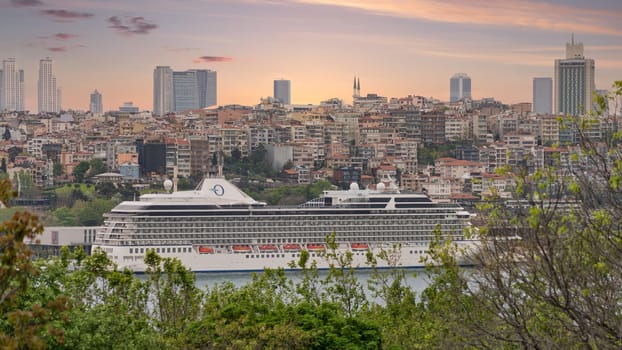 View from Topkapi palace of Bosphorus skyline with a huge cruise ship named MARINA docked at iconic Galataport cruise terminal, Istanbul, Turkey