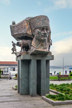 Istanbul, Turkey - May 12, 2023: Bronze statue on a tall pillar of founder of Turkish Republic, Mustafa Kemal Ataturk in a thoughtful pose, with Bosphorus in the background, in Arnavutkoy