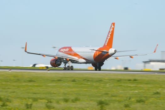 1 December 2022 PORTUGAL, LISBON: EASYJET OE-IJX airplane gaining speed on the runway. Mid shot