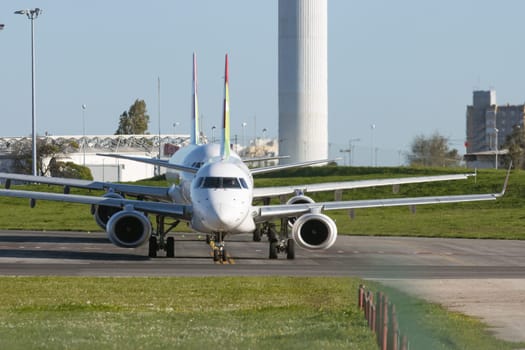 1 December 2022 PORTUGAL, LISBON: passenger planes stand in a row on the airport field. Mid shot