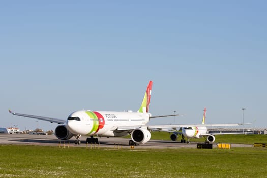 1 December 2022 PORTUGAL, LISBON: AIRPORTUGAL passenger planes standing on the field by the airport. Mid shot