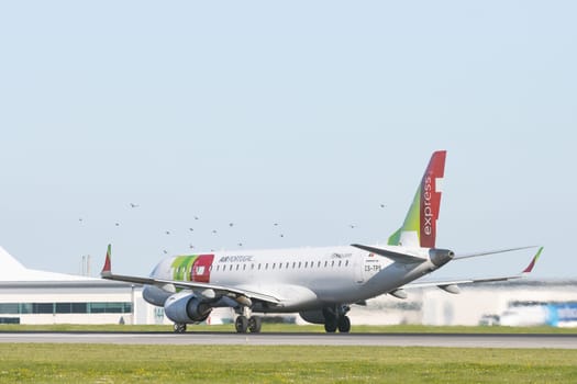 1 December 2022 PORTUGAL, LISBON: AIRPORTUGAL passenger plane riding on a runway. Mid shot