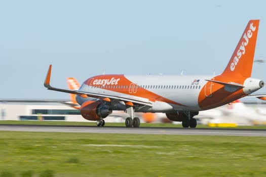 1 December 2022 PORTUGAL, LISBON: EASYJET OE-IJX plane gaining speed on the runway. Mid shot