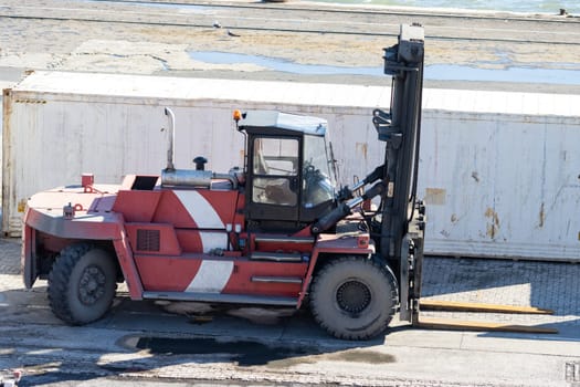Forklift with empty cab in the shipping port. Mid shot