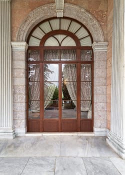 Grand entrance doorway leading to Beykoz Mecidiye Pavilion. The doorway is made of wood and glass and has ornate carvings