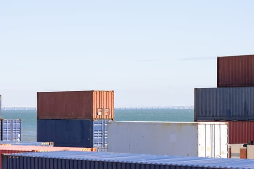 Industrial containers ready for shipping in the sea port. Mid shot