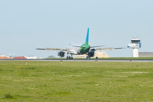 1 December 2022 PORTUGAL, LISBON: airplane with VUELING dot COM sign on the corpus landed on the runway. Mid shot