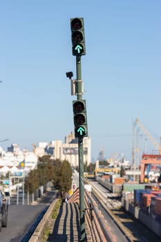 Green traffic light pointing forward at the cargo port. Mid shot