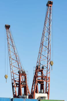 Cranes in the seaport for lifting cargo. Mid shot