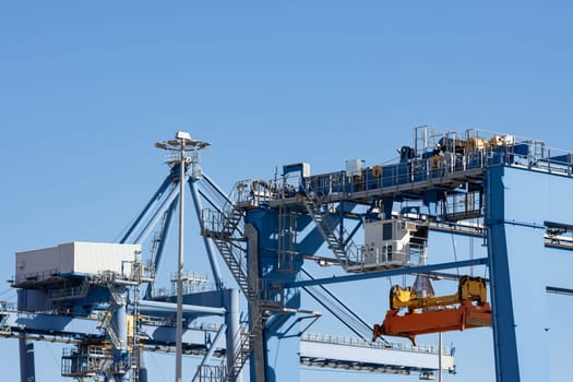Large lifting structures with suspended spreader for cargo containers. Mid shot