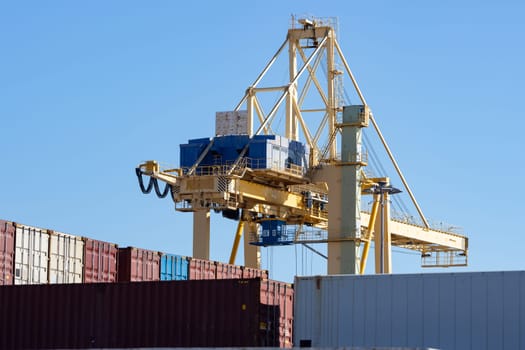 Viewpoint above the cargo seaport on the background of blue sky. Mid shot