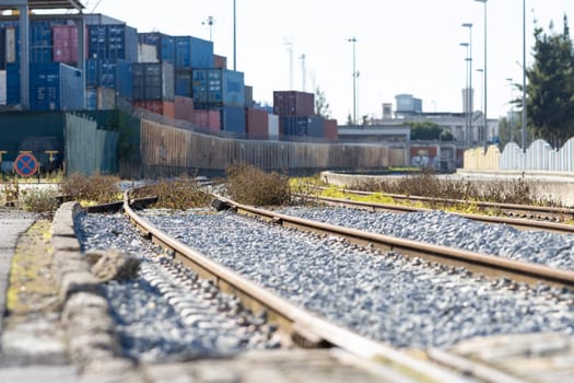 Train railways near the warehouse with a bunch of containers in the open air. Mid shot