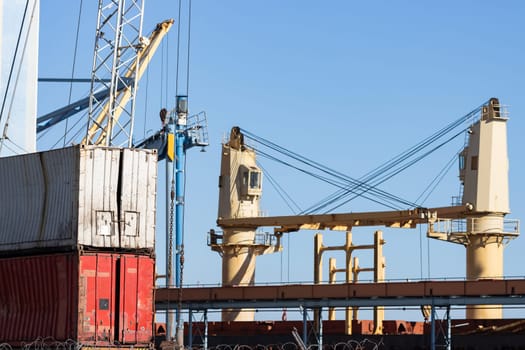 Seaport and cargo containers under the blue sky. Mid shot
