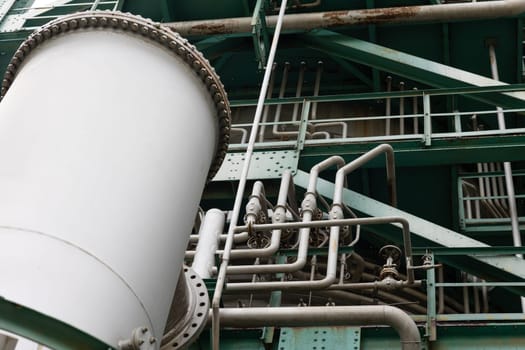 Lots of pipes on the surface of the oil and gas refining tower. Mid shot