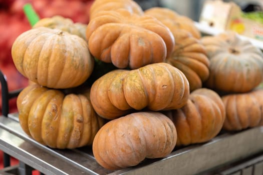 Orange pumpkins on the public outdoors market. Mid shot