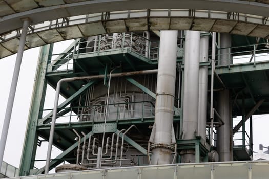 Lots of pipes on the surface of the oil and gas processing tower. Mid shot