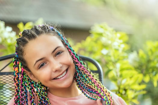Summer portrait of smiling little long haired girl. . Horizontally.