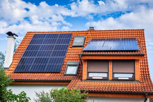 Photovoltaic panels on the roof of family house, solar panels. Environment and technology concepts.