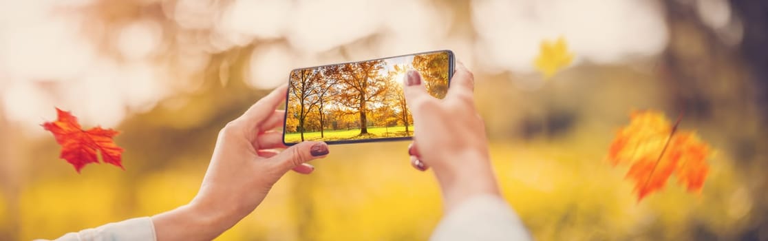 Woman making photo on the smart phone of nature outdoors. Concept of the travelling, vacation and background.