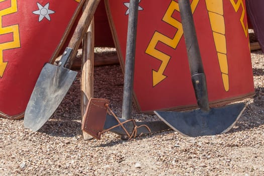 Entrenching tools supported in shields. Digging tools used by ancient roman army