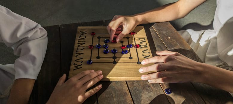 Reenactors playing molendinum, ancient roman board game