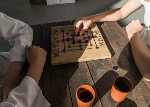 Reenactors playing molendinum, ancient roman board game