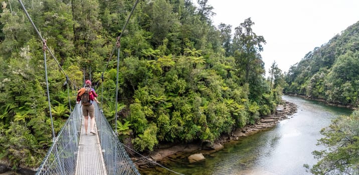 Crossing a suspension footbridge at Abel Tasman Cost Track