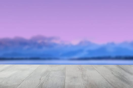 Empty wooden table over abstract blurred evening or sunset mood background texture with blue ocean and blue clouds with pink sunny sky.Space.