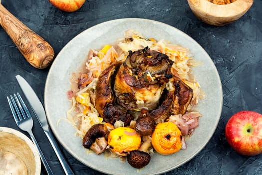 Roasted pork knuckle eisbein or knee cooked in dark beer and apples. Octoberfest party.