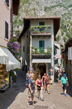 Tourists in the medieval old town of Limone Sul Garda on Lake Garda in Italy