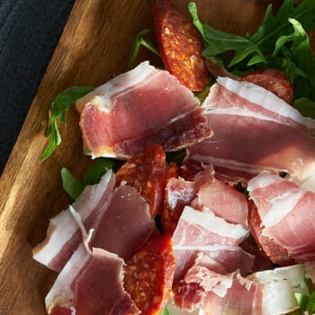 hearty snack in a restaurant in Italy with ham, salami, rocket and cheese