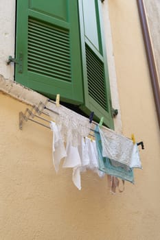 hanging laundry on the window of a house in the old town of Limone Sul Garda on Lake Garda in Italy