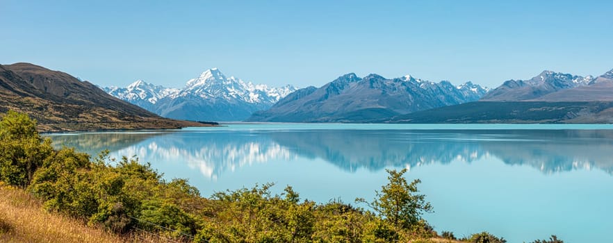 Scenic reflection of Mount Sefton and Mount Cook at lake Pukaki, South Island of New Zealand