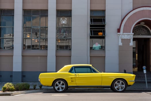 Vintage car parking in front of an Art Deco building in downtown Napier, North Island of New Zealand