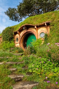 HOBBITON, NEW ZEALAND - JANUARY 20, 2023 - Bilbo Baggin's hobbit hole in Hobbiton village from the movies The Hobbit and Lord of the Rings, New Zealand