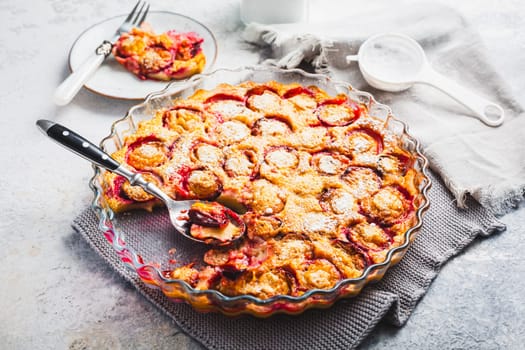 Flaugnarde or Clafoutis - French dessert with plums, large pancake baked in oven