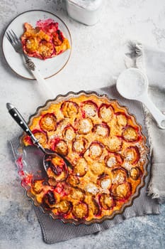 Flaugnarde or Clafoutis - French dessert with plums, large pancake baked in oven