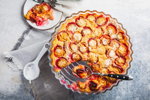 Flaugnarde or Clafoutis - French dessert with plums, large pancake baked in oven