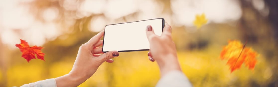 Woman making photo on the smart phone of nature outdoors. Concept of the travelling, vacation and background.